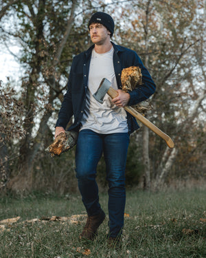 Man in flannel and jeans outdoors