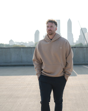 Man wearing Barbell Foundation Hoodie with City backdrop