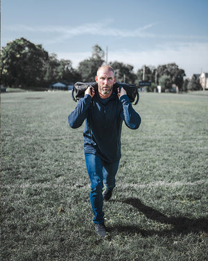 man working out on football field doing lunges