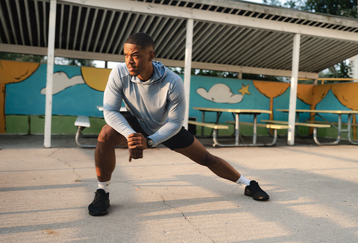 model in arid hoodie and barbell shorts