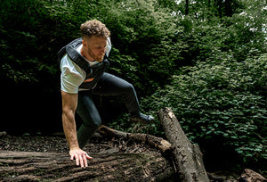 Man in weighted vest and Covert pants in the forest
