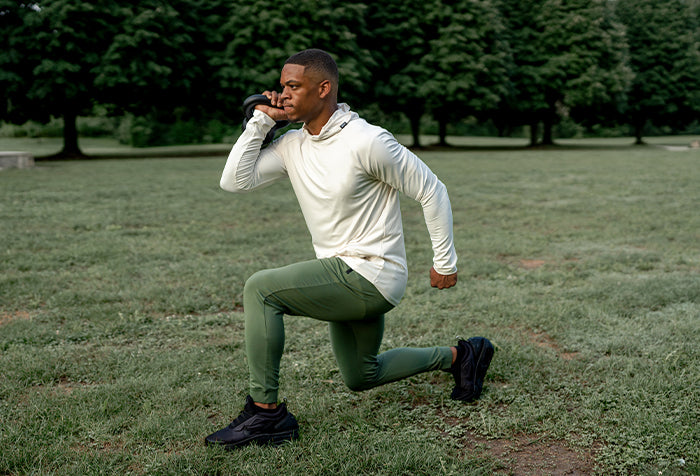 Man in barbell stealth hoodie and Recon Joggers in sage
